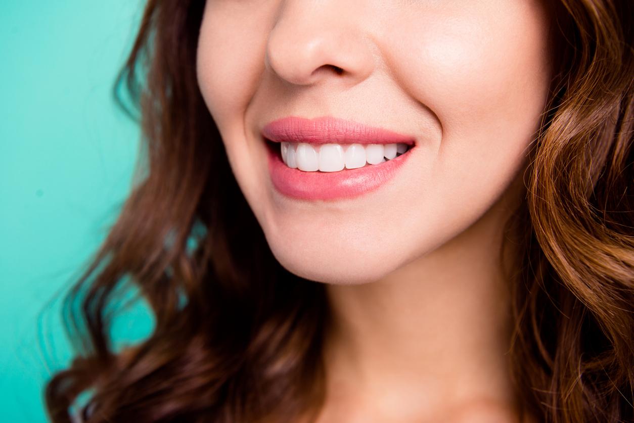 Up-close view of a woman's clean white smile after a dental cleaning Up-close view of a woman's clean white smile after a dental cleaning